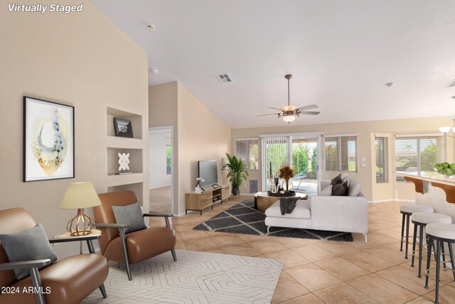 spare room featuring ceiling fan, light tile patterned flooring, a healthy amount of sunlight, and built in shelves