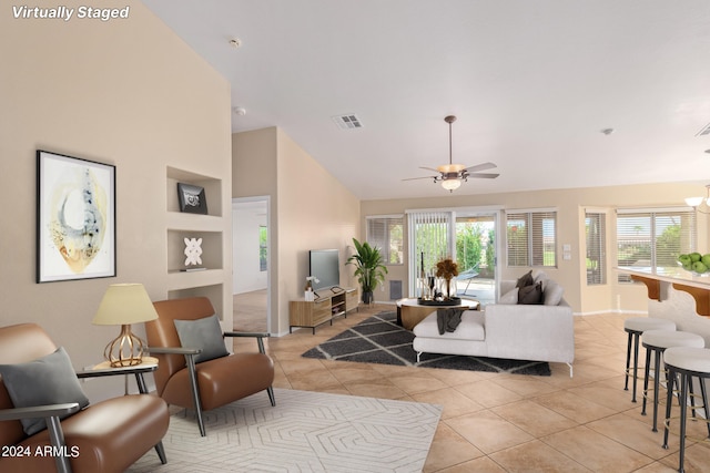 tiled living room featuring ceiling fan and high vaulted ceiling