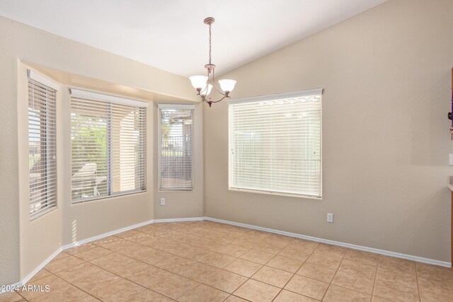 kitchen featuring hanging light fixtures, light tile patterned floors, a breakfast bar area, a center island, and white appliances