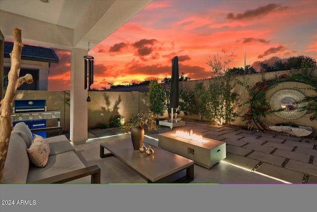 patio terrace at dusk featuring a fire pit