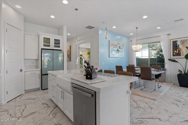 kitchen featuring sink, pendant lighting, a kitchen island with sink, white cabinets, and appliances with stainless steel finishes