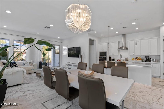 dining room featuring sink and an inviting chandelier