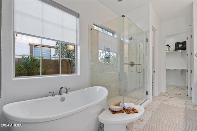 bathroom with shower with separate bathtub