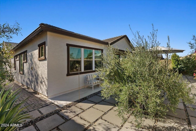 view of side of property featuring a patio