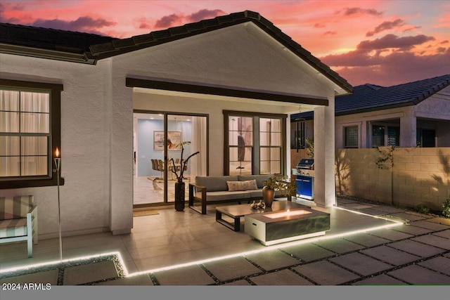 patio terrace at dusk featuring outdoor lounge area