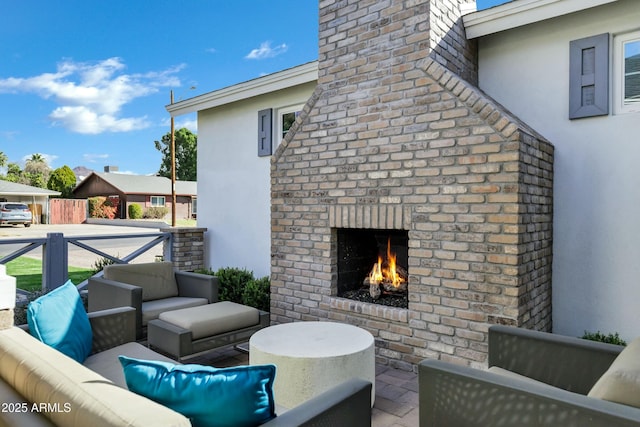 view of patio / terrace with an outdoor living space with a fireplace