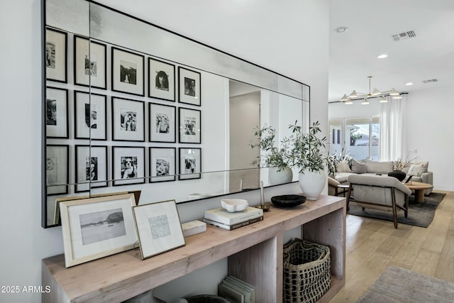 room details with recessed lighting, wood finished floors, and visible vents