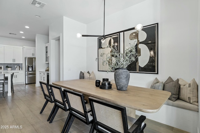 dining space featuring recessed lighting, visible vents, and light wood-style floors