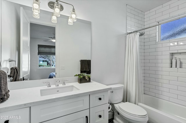 ensuite bathroom featuring vanity, ensuite bath, ceiling fan, shower / bath combination with curtain, and toilet