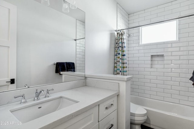 full bathroom featuring vanity, toilet, and shower / tub combo