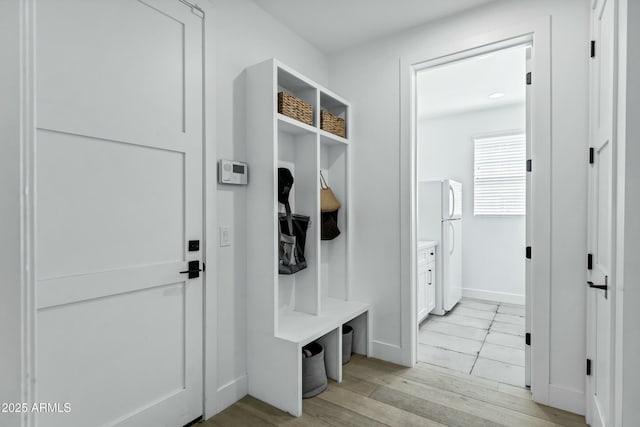 mudroom featuring light wood-type flooring and baseboards