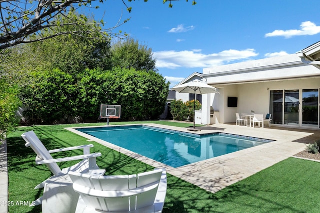 pool with a lawn and a patio