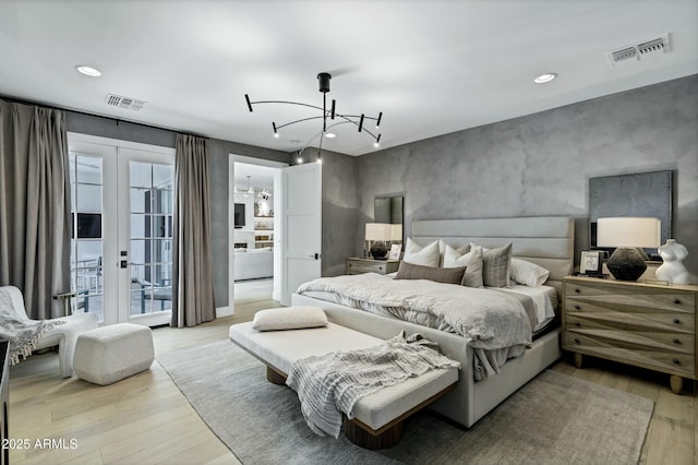 bedroom with a chandelier, visible vents, light wood-type flooring, and access to outside