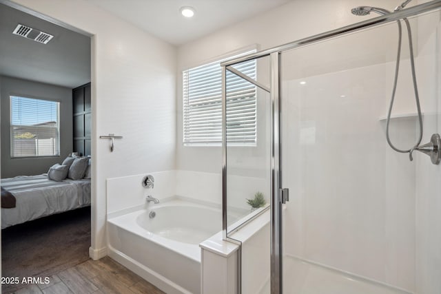2335 W Sunland Ave, Phoenix, AZ 85041 - bathroom with a stall shower, a bath, connected bathroom, and recessed lighting