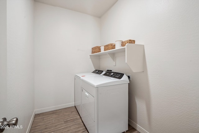 2335 W Sunland Ave, Phoenix, AZ 85041 - laundry area featuring washing machine and dryer, light wood-type flooring, and baseboards