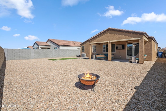 2335 W Sunland Ave, Phoenix, AZ 85041 - back of property with an outdoor fire pit, a patio area, a fenced backyard, central AC, and a tiled roof