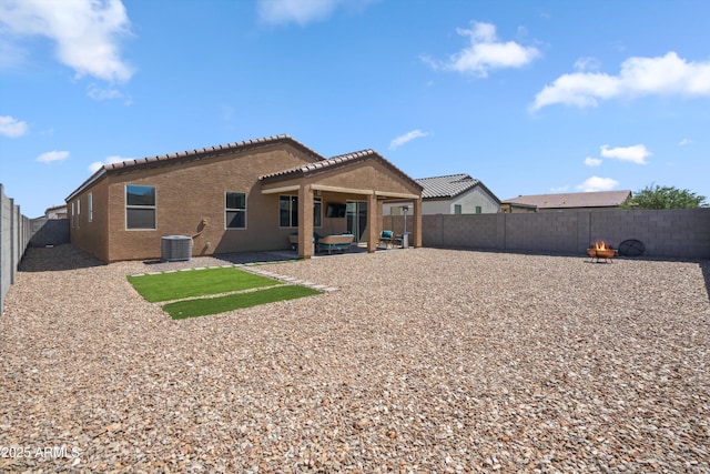 2335 W Sunland Ave, Phoenix, AZ 85041 - back of property featuring central air condition unit, a fenced backyard, a tile roof, an outdoor fire pit, and a patio
