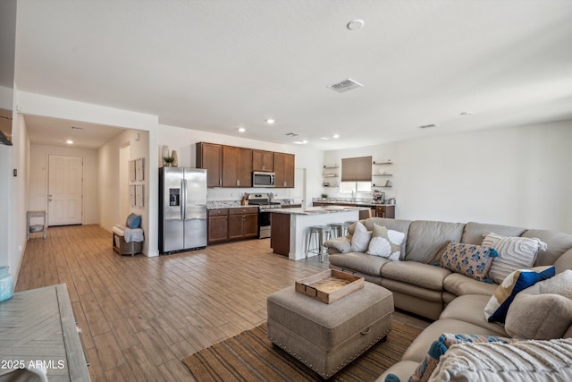 2335 W Sunland Ave, Phoenix, AZ 85041 - living room with wood finished floors and recessed lighting