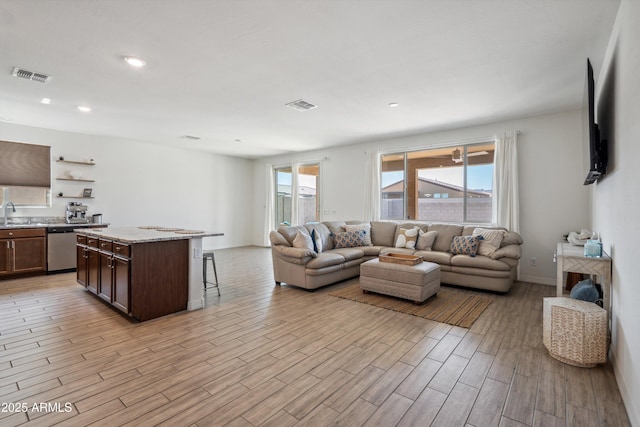 2335 W Sunland Ave, Phoenix, AZ 85041 - living area with light wood finished floors, recessed lighting, and baseboards