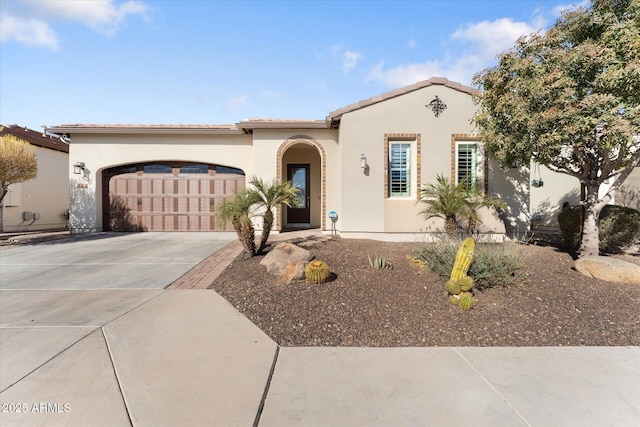 mediterranean / spanish-style home with a garage