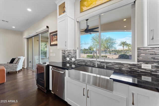 kitchen with white cabinets, sink, stainless steel dishwasher, ceiling fan, and beverage cooler