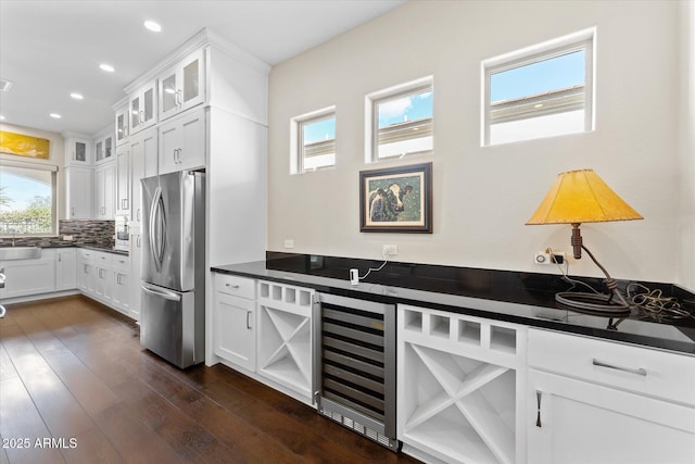 kitchen featuring white cabinetry, stainless steel fridge, and beverage cooler