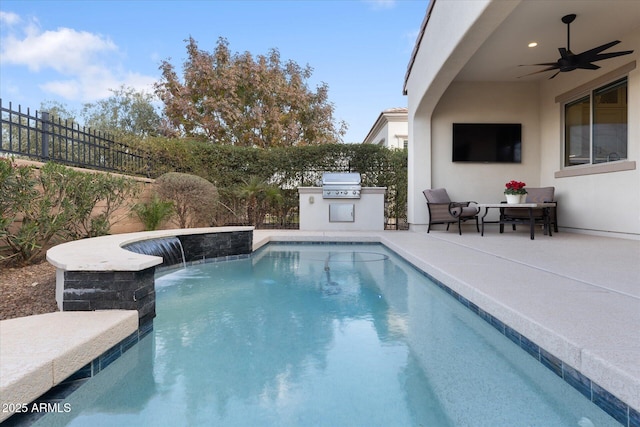 view of pool featuring an outdoor kitchen, pool water feature, ceiling fan, grilling area, and a patio