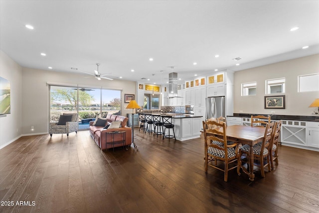 dining area with ceiling fan and dark hardwood / wood-style flooring