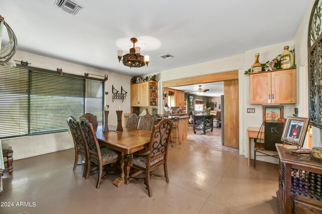 dining space with a notable chandelier and concrete flooring