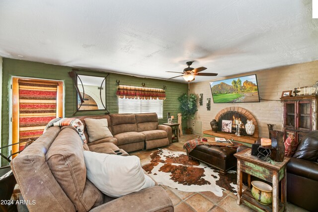 kitchen featuring a textured ceiling, backsplash, stainless steel appliances, sink, and ceiling fan