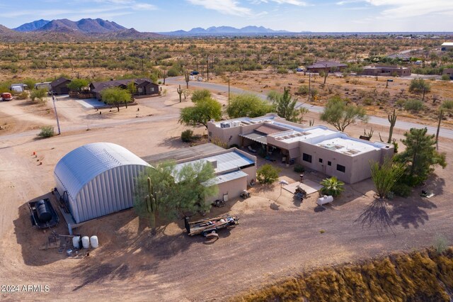 birds eye view of property with a mountain view