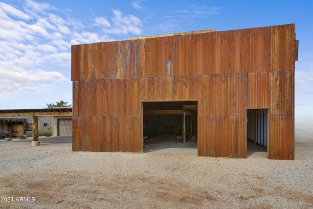 misc room with vaulted ceiling and concrete flooring