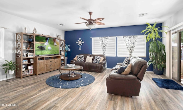 living room featuring ceiling fan and hardwood / wood-style floors