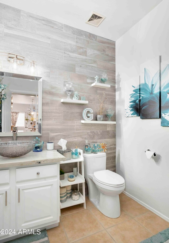 bathroom featuring tile walls, vanity, toilet, and tile patterned floors