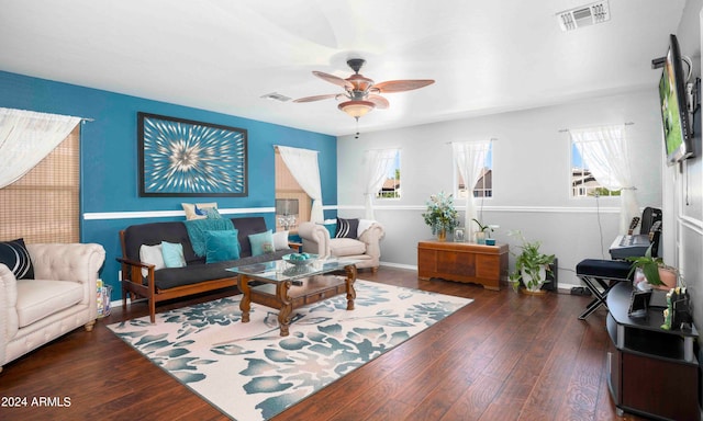 living room with ceiling fan and dark wood-type flooring