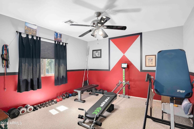 exercise room with ceiling fan and carpet