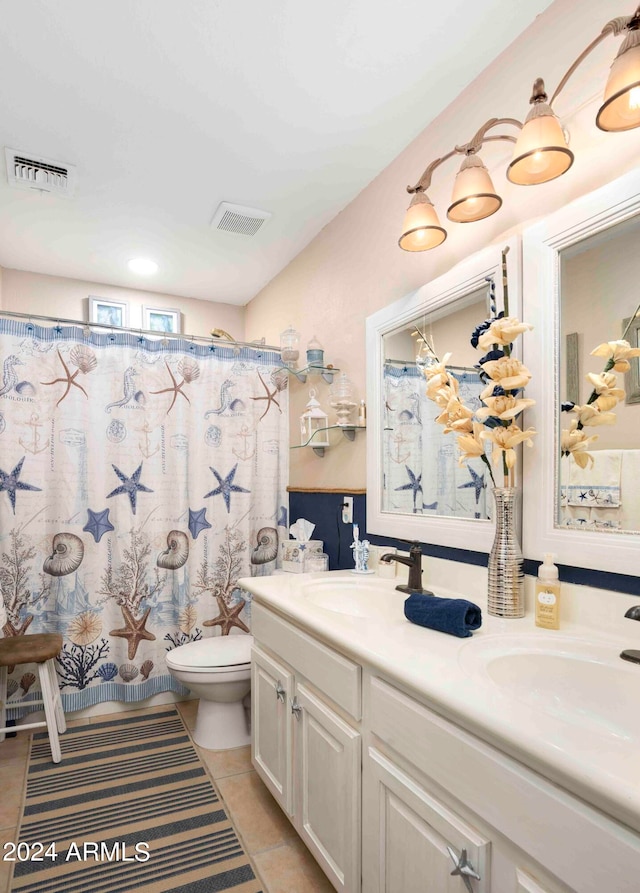 bathroom featuring curtained shower, vanity, toilet, and tile patterned floors