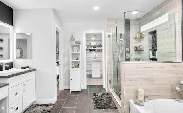 bathroom featuring tile patterned flooring, vanity, and plus walk in shower