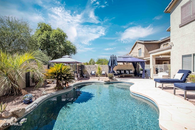 view of swimming pool featuring a patio and a gazebo