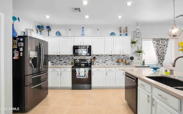 kitchen with white cabinets, hanging light fixtures, sink, light tile patterned floors, and stainless steel appliances