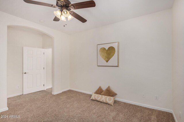 interior space with ceiling fan and carpet