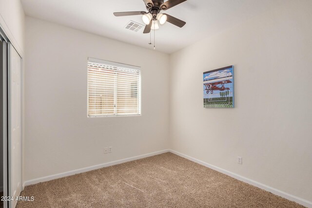 empty room with carpet and ceiling fan