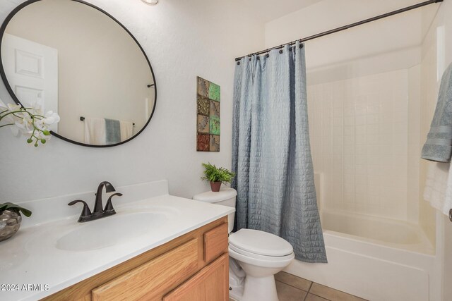 full bathroom with vanity, tile patterned flooring, shower / bathtub combination with curtain, and toilet