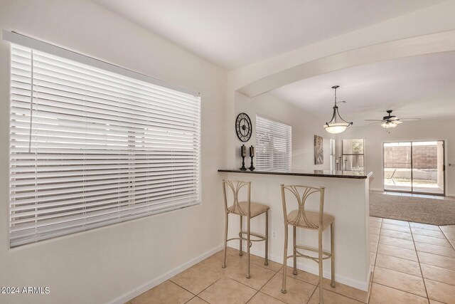 tiled empty room featuring ceiling fan