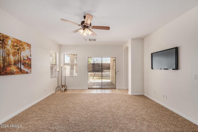 kitchen featuring ceiling fan, kitchen peninsula, decorative light fixtures, a breakfast bar, and light tile patterned floors