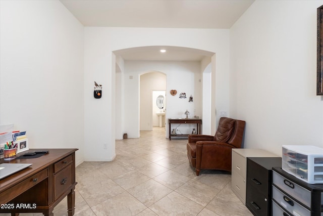 interior space with light tile patterned floors and arched walkways