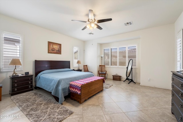 bedroom featuring multiple windows, visible vents, and light tile patterned flooring