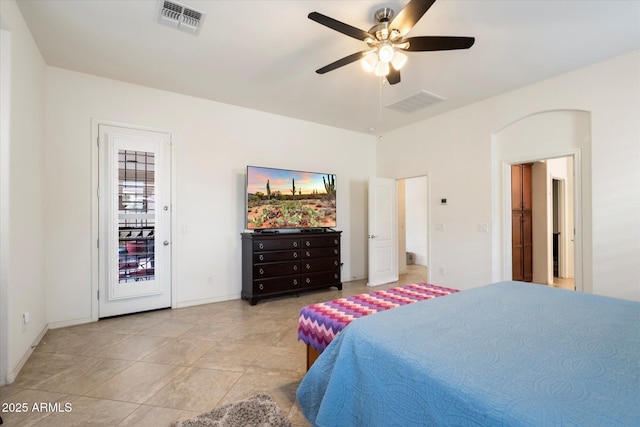 bedroom featuring a ceiling fan, arched walkways, access to outside, and visible vents