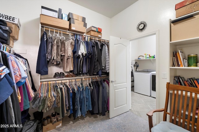 spacious closet featuring washer / dryer and tile patterned flooring