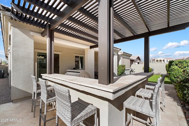 view of patio / terrace featuring outdoor dry bar, fence, and a pergola